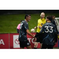 Gio Miglietti (left) receives congratulations from Tacoma Defiance teammate Cody Baker