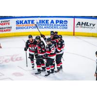 Belleville Senators exchange congratulations after a goal